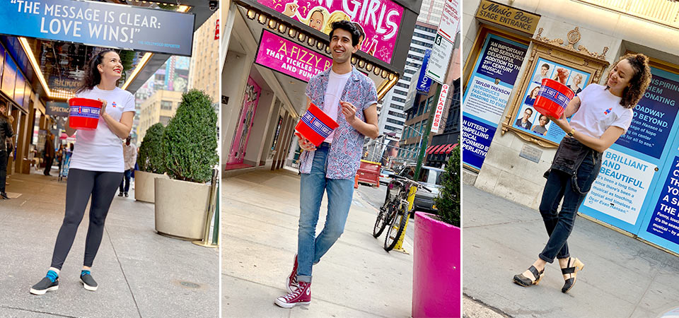 Broadway actors holding red buckets